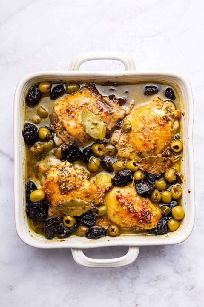 Overhead view of chicken marbella in baking dish