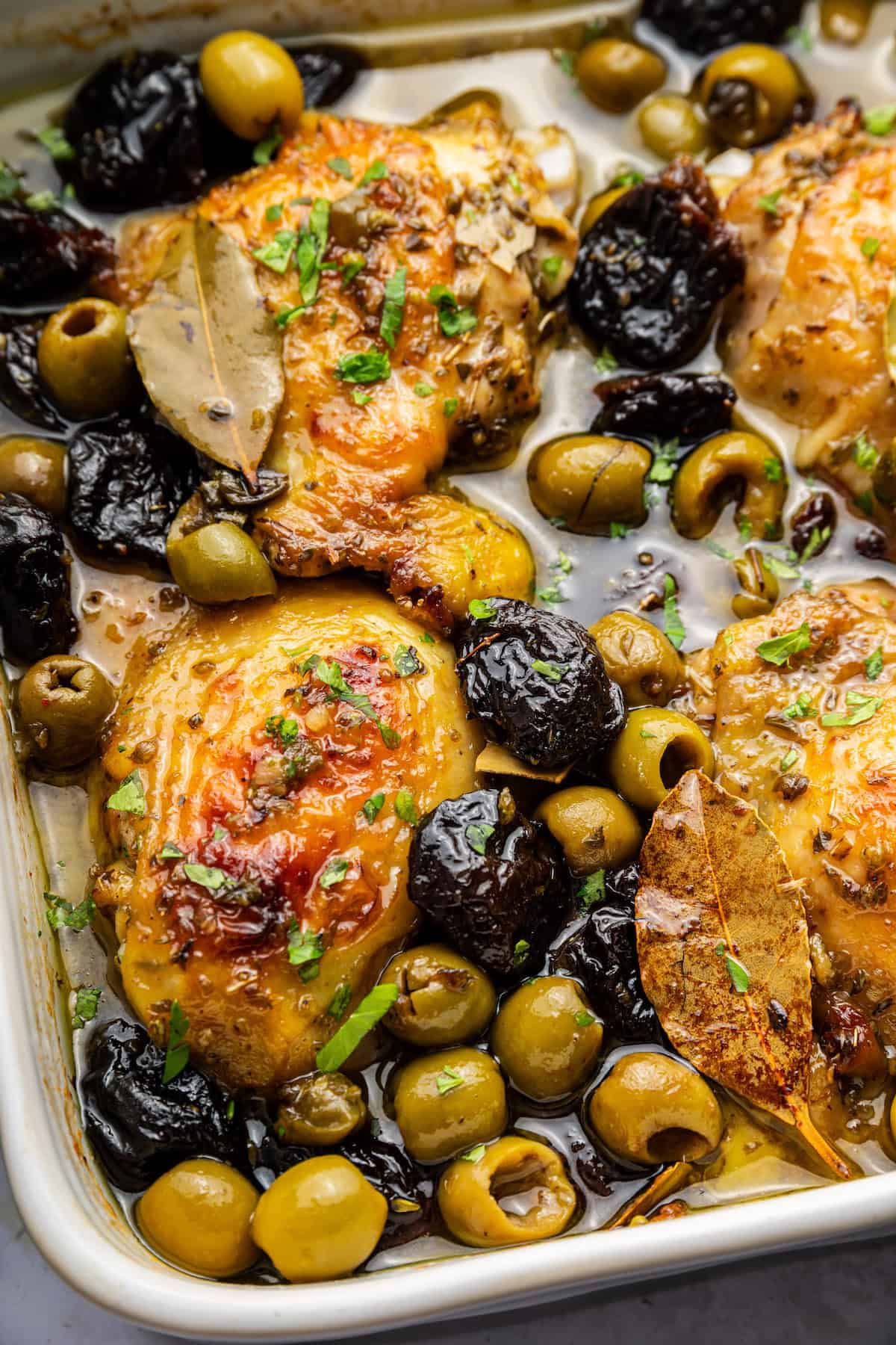 Overhead view of chicken marbella in baking dish