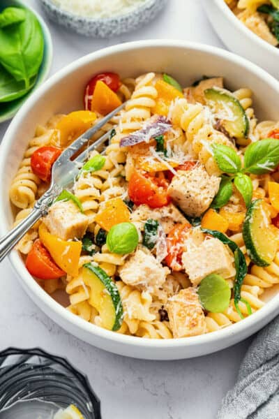 Bowl of chicken pasta primavera with fork