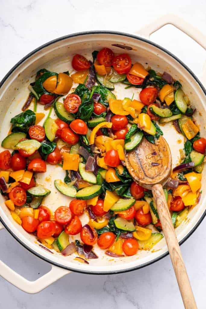 Overhead view of vegetables cooking in pan