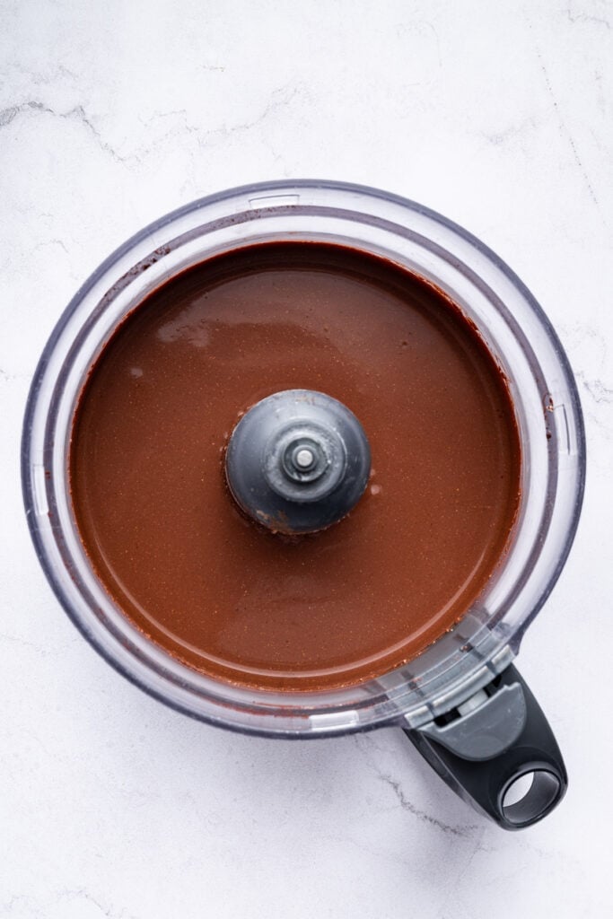 Blended chocolate cottage cheese mixture in food processor