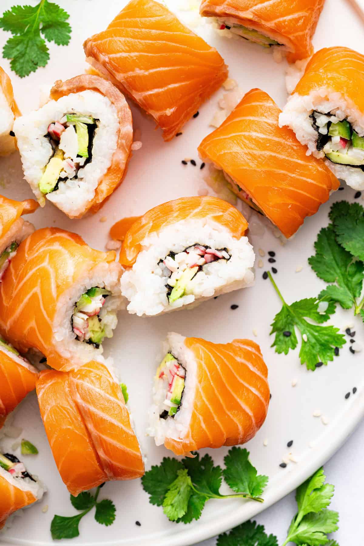 Overhead view of sliced Alaska roll on plate