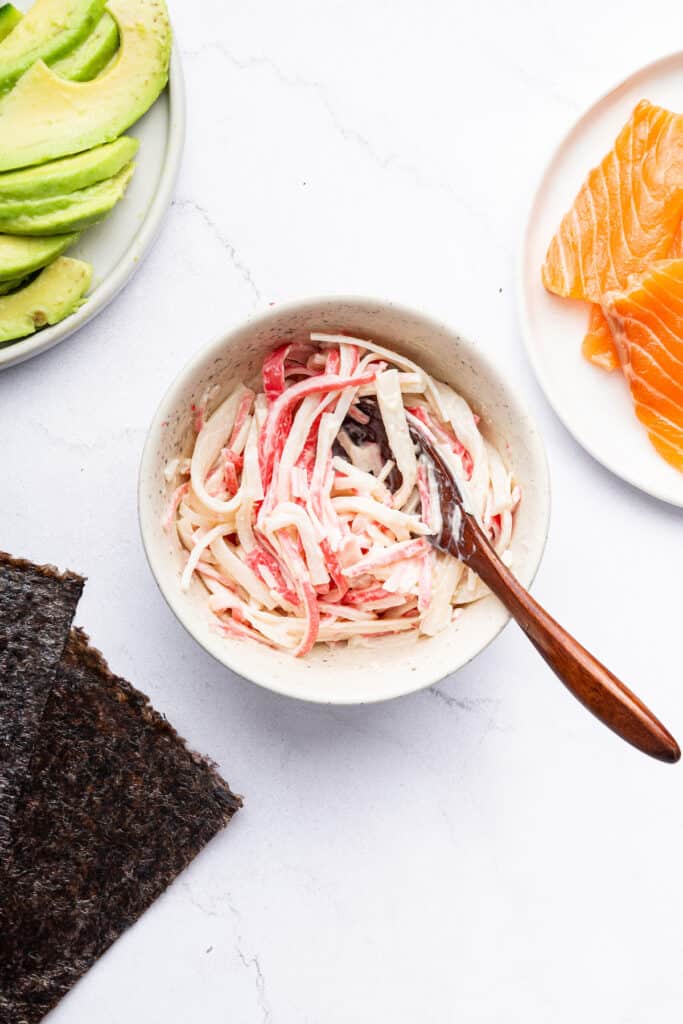 Overhead view of crab and mayo in bowl with spoon