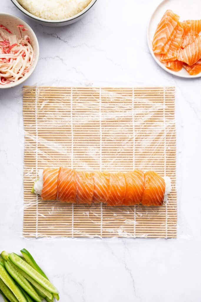 Overhead view of Alaska roll on sushi mat