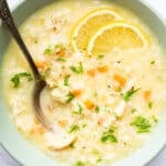 Bowl of avgolemono soup with fresh lemon slices