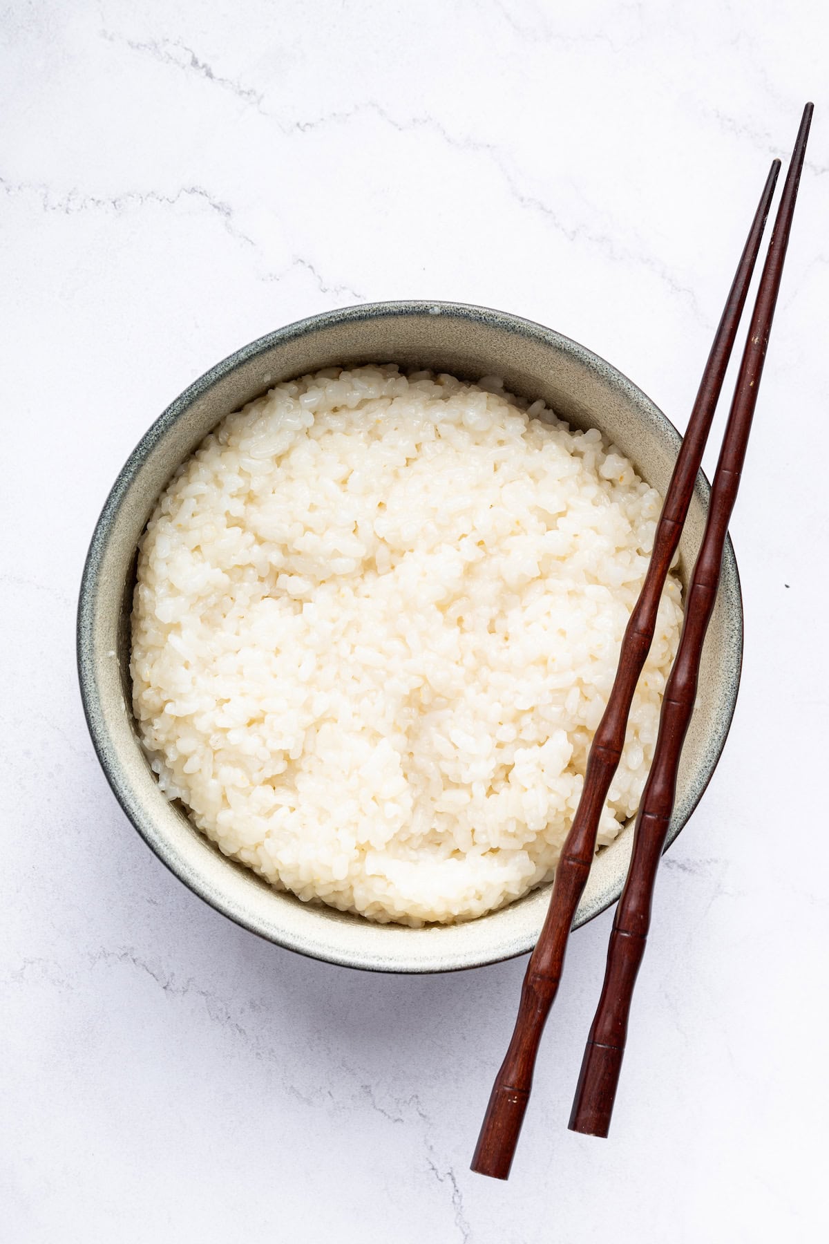 Overhead view of Instant Pot sushi rice in bowl with chopsticks