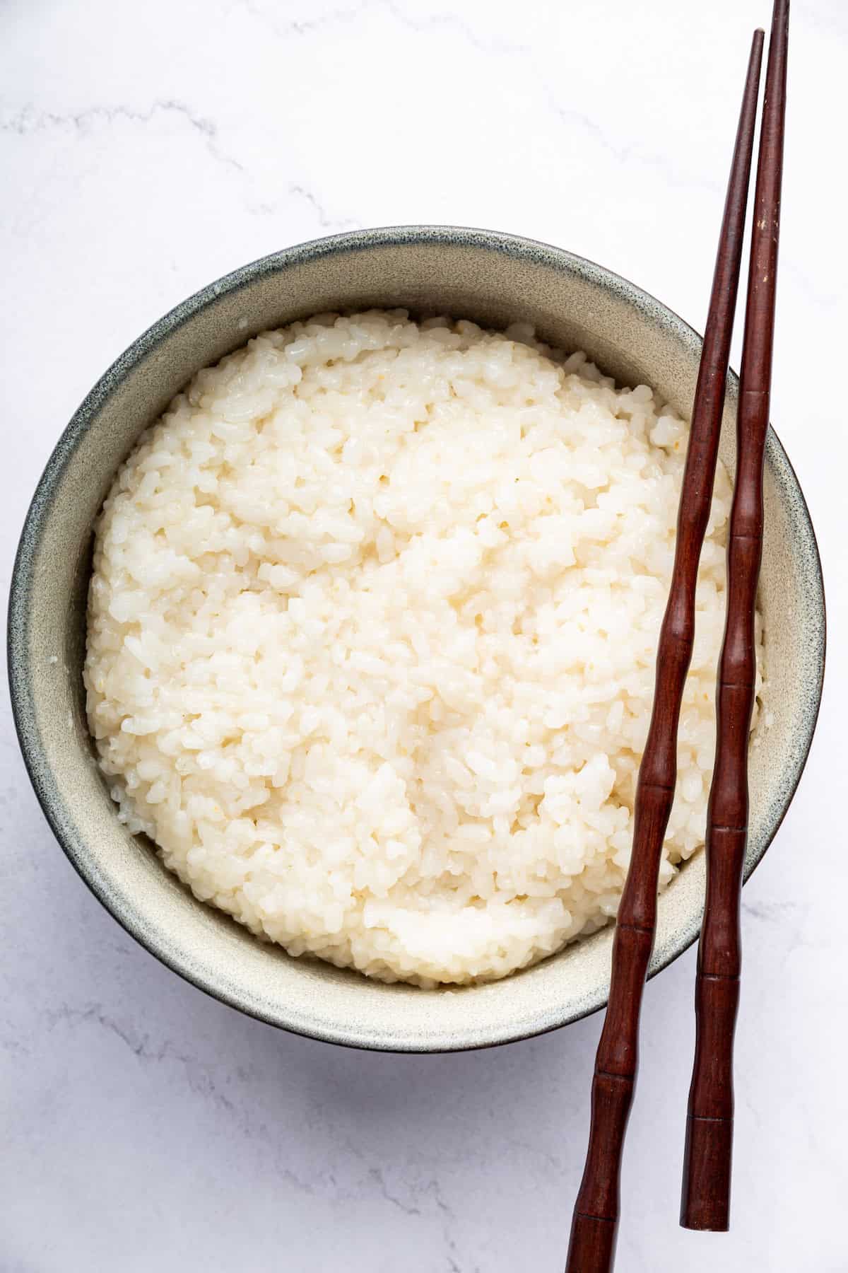 Overhead view of Instant Pot sushi rice in bowl with chopsticks