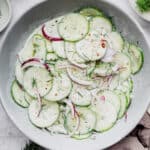 Overhead view of creamy cucumber salad in serving bowl