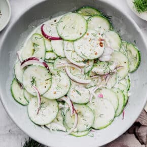Overhead view of creamy cucumber salad in serving bowl