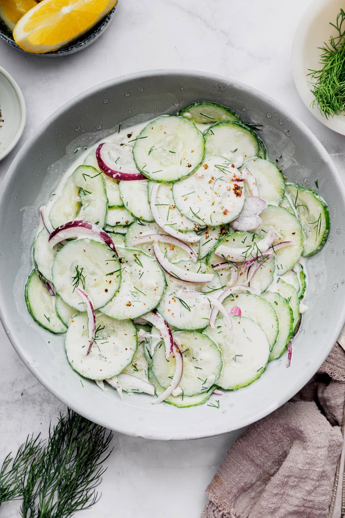 Overhead view of creamy cucumber salad in serving bowl