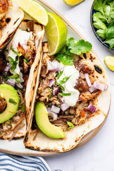 Tacos made with Instant Pot pork carnitas on plate