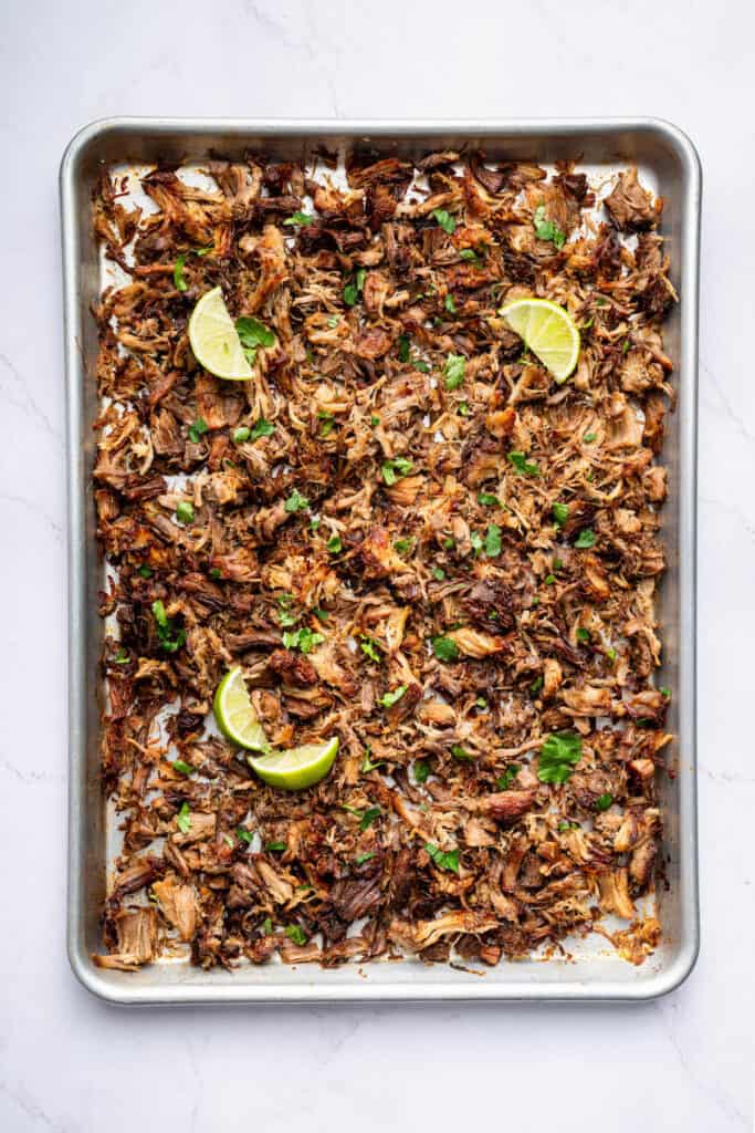 Overhead view of shredded Instant Pot carnitas on sheet pan