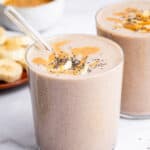 Peanut butter banana smoothie in two glasses