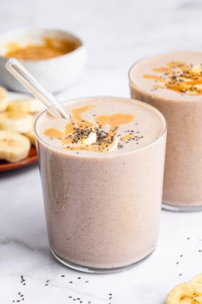 Peanut butter banana smoothie in two glasses