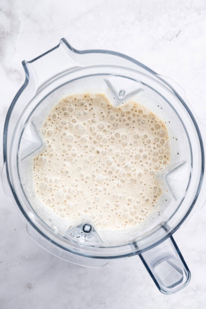 Overhead view of peanut butter banana smoothie in blender
