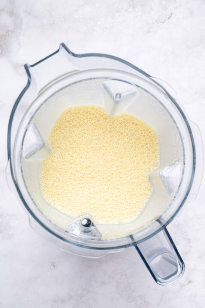 Cottage cheese pancakes are tender and fluffy, with more protein than a traditional pancake. Stash some in the freezer for easy breakfasts! Overhead view of blended wet ingredients for cottage cheese pancakes