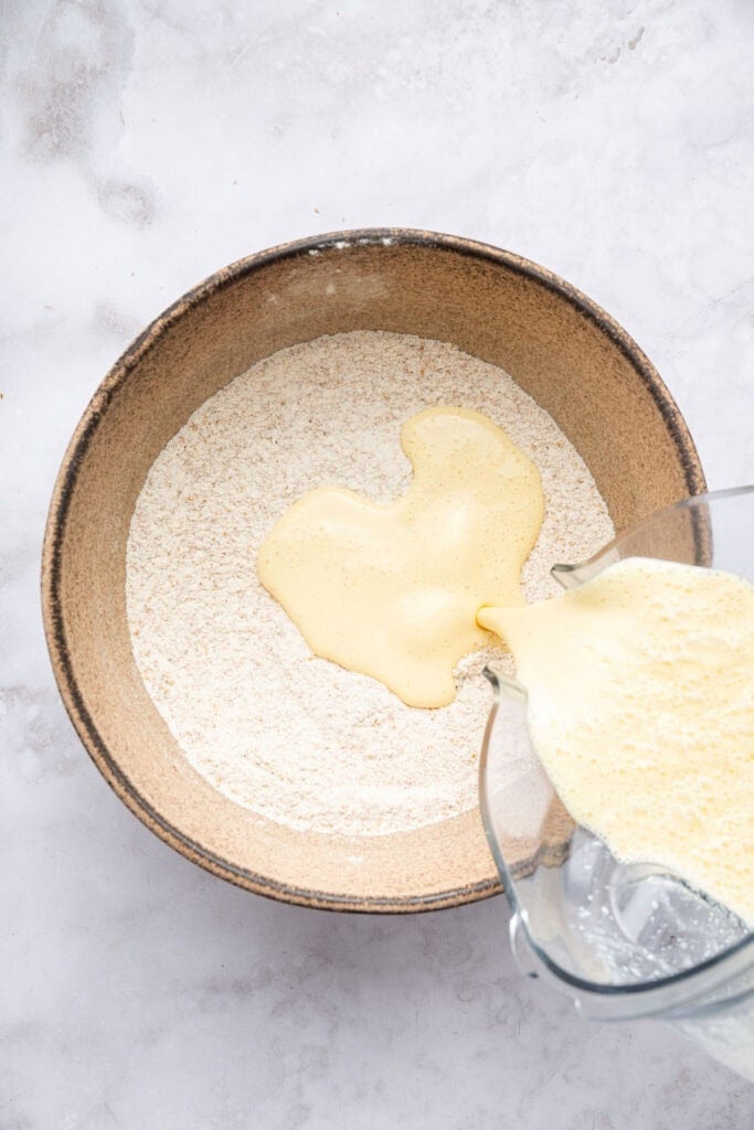 Cottage cheese pancakes are tender and fluffy, with more protein than a traditional pancake. Stash some in the freezer for easy breakfasts! Pouring liquid ingredients into dry ingredients for cottage cheese pancakes