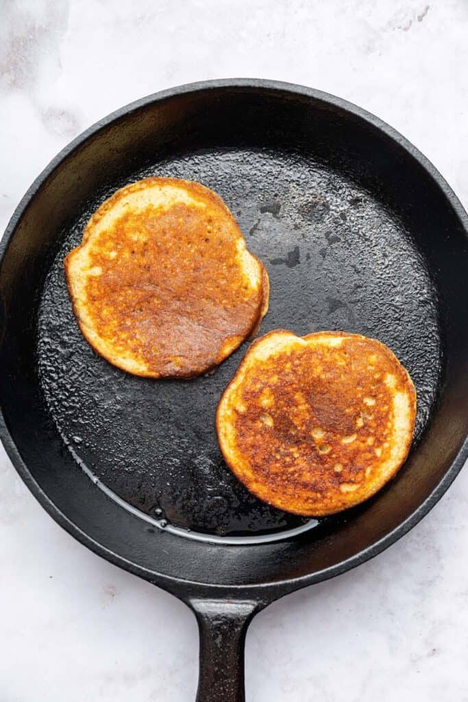 Cottage cheese pancakes are tender and fluffy, with more protein than a traditional pancake. Stash some in the freezer for easy breakfasts! Overhead view of pancakes cooking in skillet
