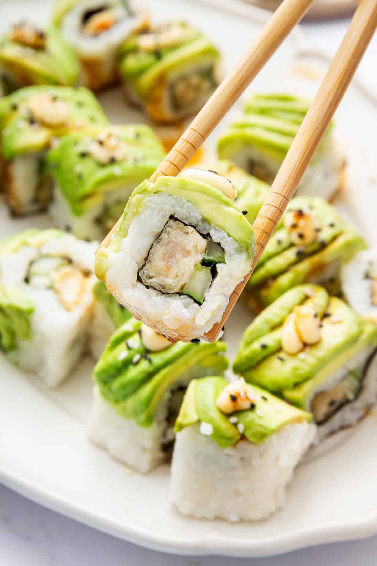 Picking up dragon roll with chopsticks