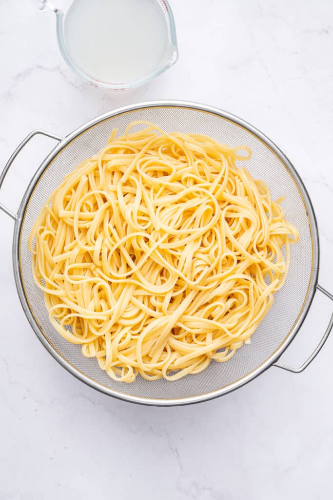 Overhead view of fettuccine in colander