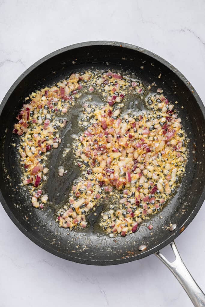 Red onion and garlic cooking in butter and oil in skillet