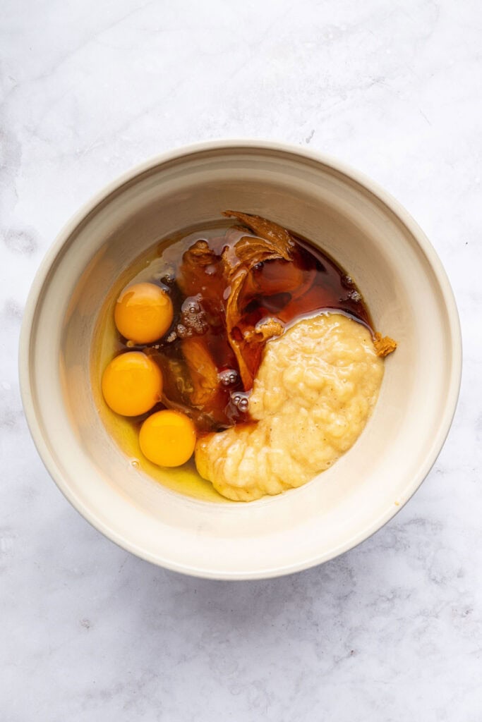 These peanut butter banana muffins are a wholesome way to start your day and I add an unexpected ingredient to make them tender and moist! Bowl of wet ingredients for muffins before mixing