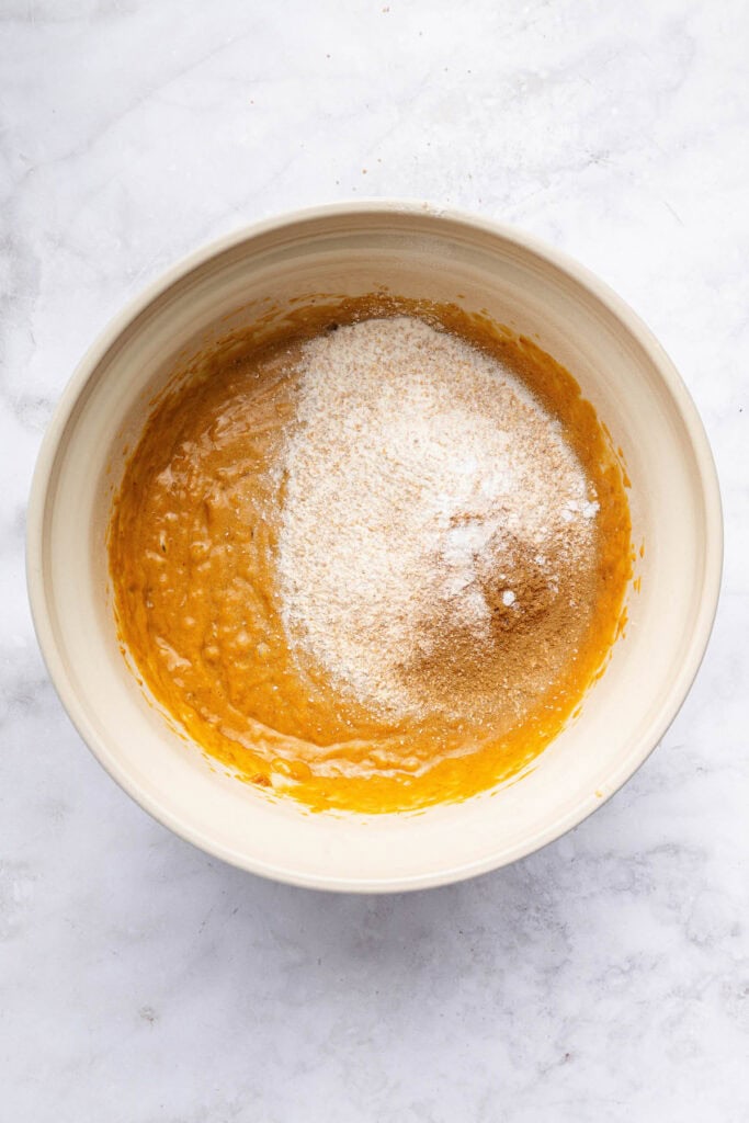 These peanut butter banana muffins are a wholesome way to start your day and I add an unexpected ingredient to make them tender and moist! Dry ingredients added to wet ingredients for peanut butter banana muffins