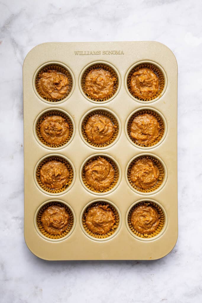These peanut butter banana muffins are a wholesome way to start your day and I add an unexpected ingredient to make them tender and moist! Overhead view of batter for peanut butter banana muffins in pan