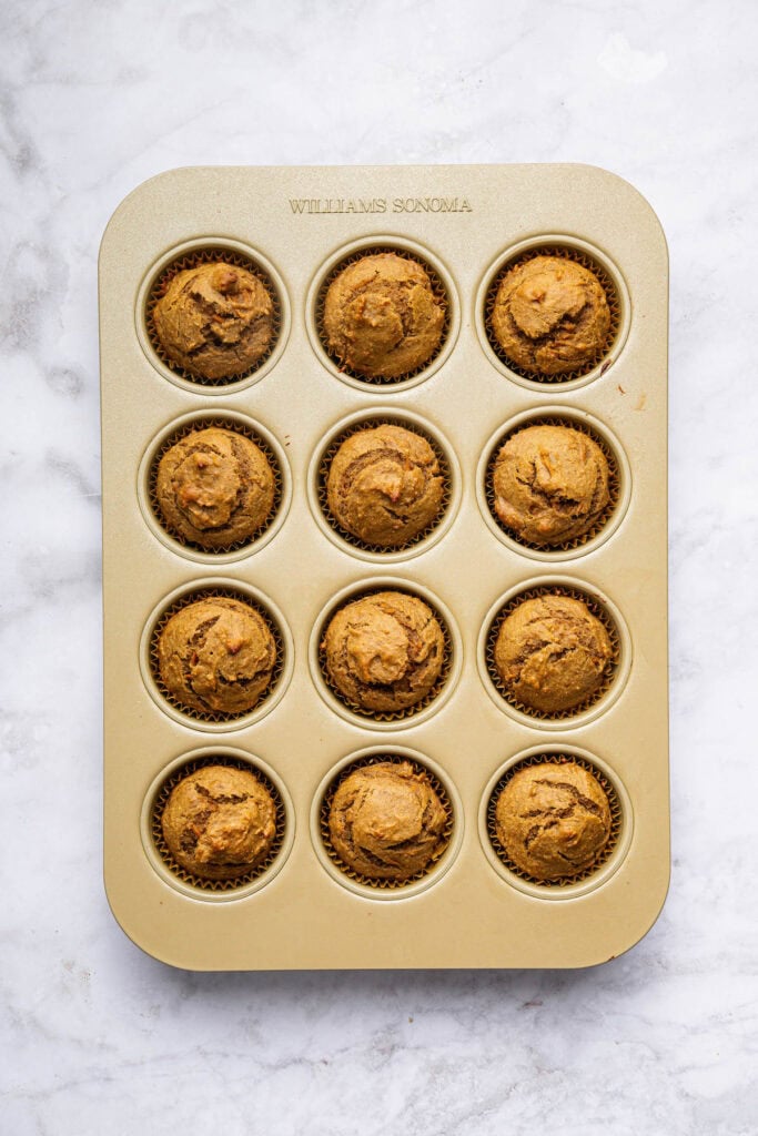 These peanut butter banana muffins are a wholesome way to start your day and I add an unexpected ingredient to make them tender and moist! Overhead view of peanut butter banana muffins in pan
