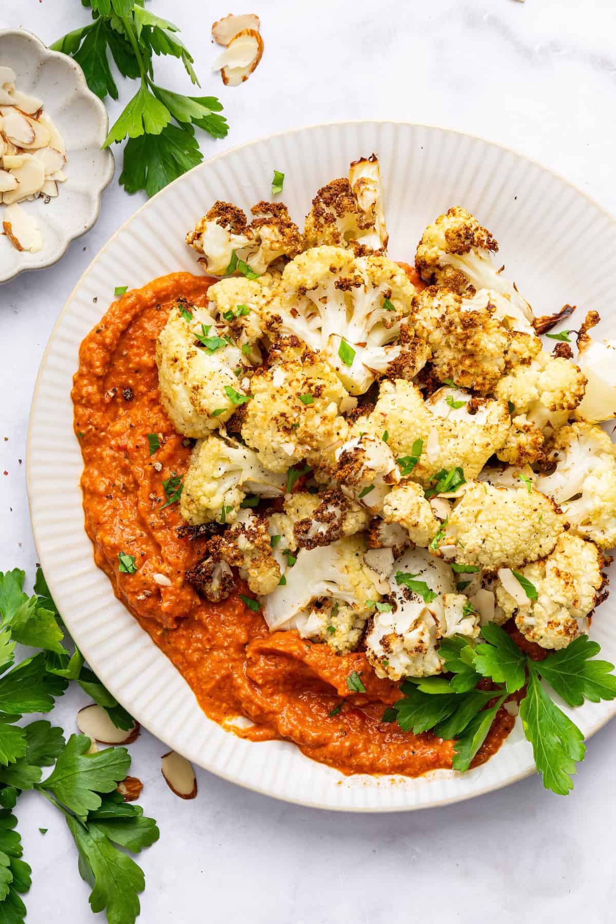 Roasted cauliflower on plate with romesco sauce