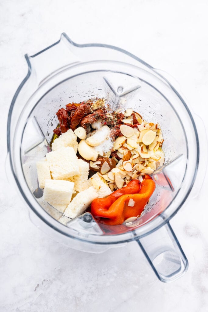 Overhead view of ingredients for romesco sauce in blender