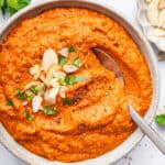 Overhead view of romesco sauce in bowl with spoon