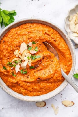 Overhead view of romesco sauce in bowl with spoon