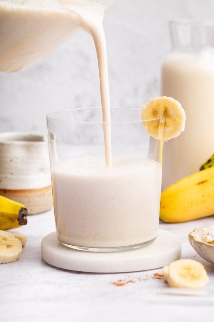 Pouring banana milk into glass
