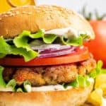 Closeup of chicken burger on sesame seed bun