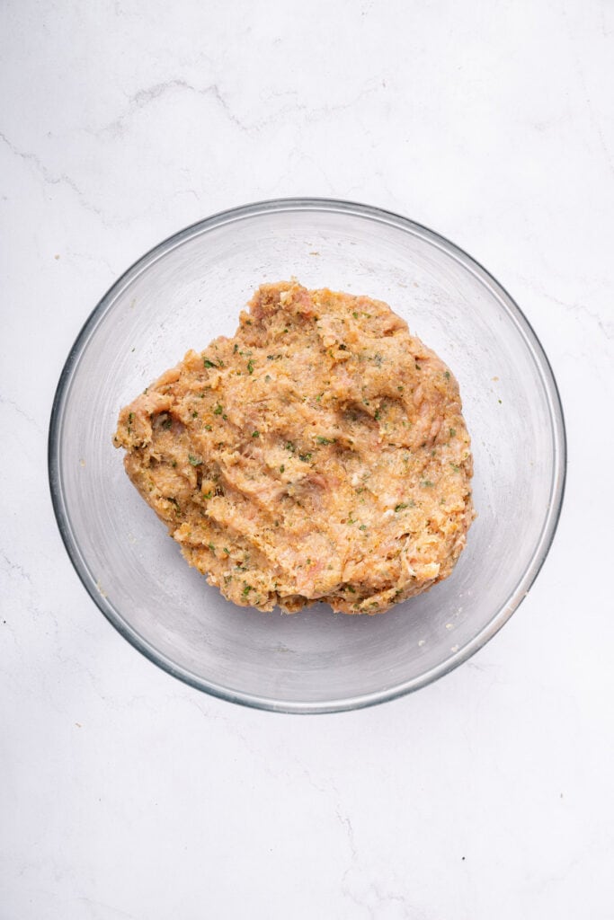 Overhead view of chicken burger mixture in bowl