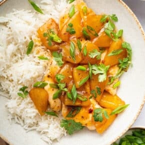 Overhead view of pineapple chicken in bowl with white rice