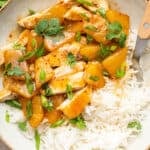 Overhead view of pineapple chicken in bowl with white rice