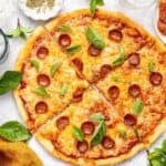 Overhead view of sliced protein pizza topped with pepperoni and cheese