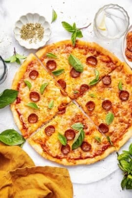 Overhead view of sliced protein pizza topped with pepperoni and cheese