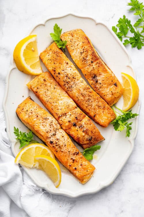 Overhead view of air fryer frozen salmon fillets