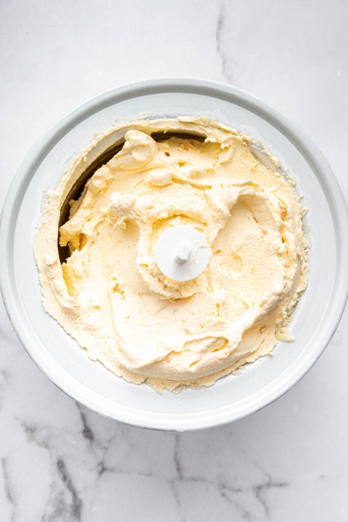 Overhead view of peach ice cream in ice cream maker