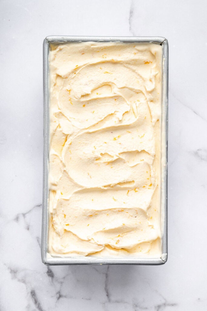 Overhead view of peach ice cream in loaf pan