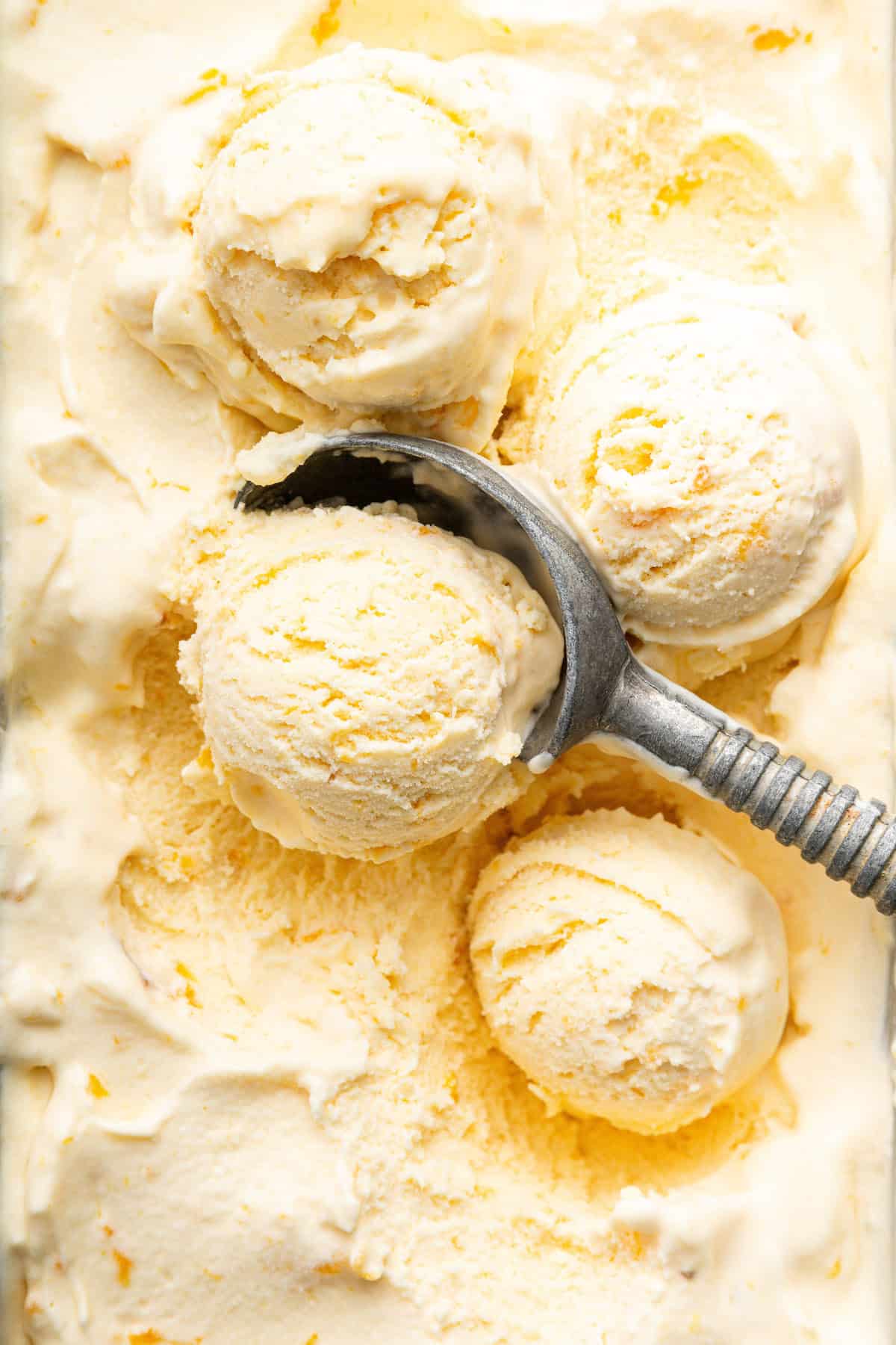 Ice cream scoop scooping homemade peach ice cream