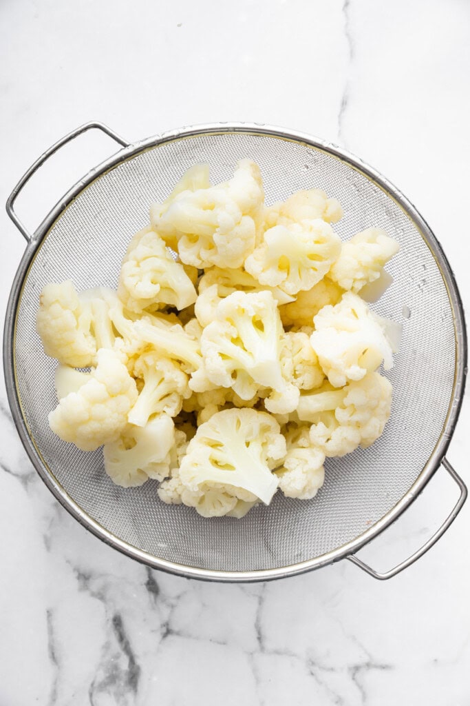 Overhead view of cauliflower in colander