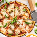Overhead view of sliced cauliflower crust pizza