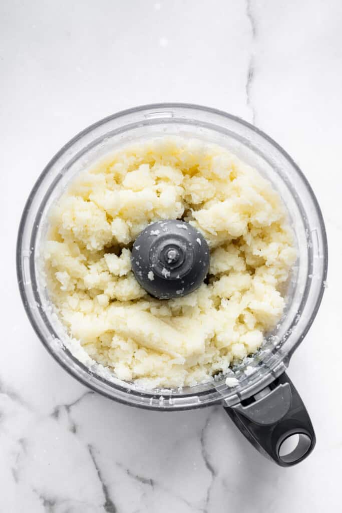 Overhead view of pulsed cauliflower in food processor