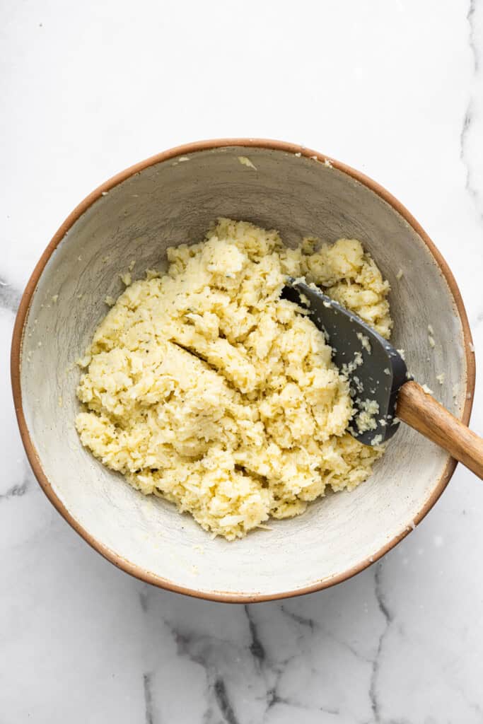 Overhead view of dough for cauliflower pizza crust in bowl
