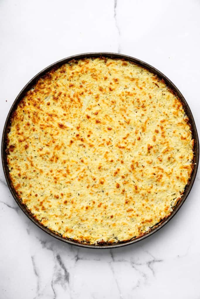 Overhead view of cauliflower crust baked in pan