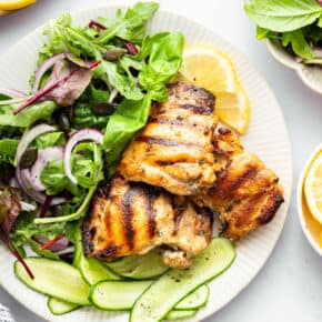 Overhead view of Greek yogurt chicken on plate with salad